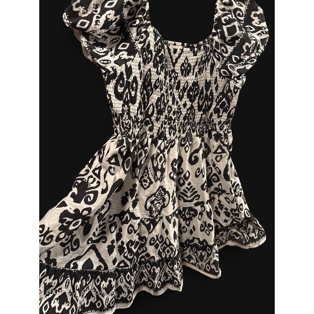 Black and white patterned peasant blouse with smocked bodice